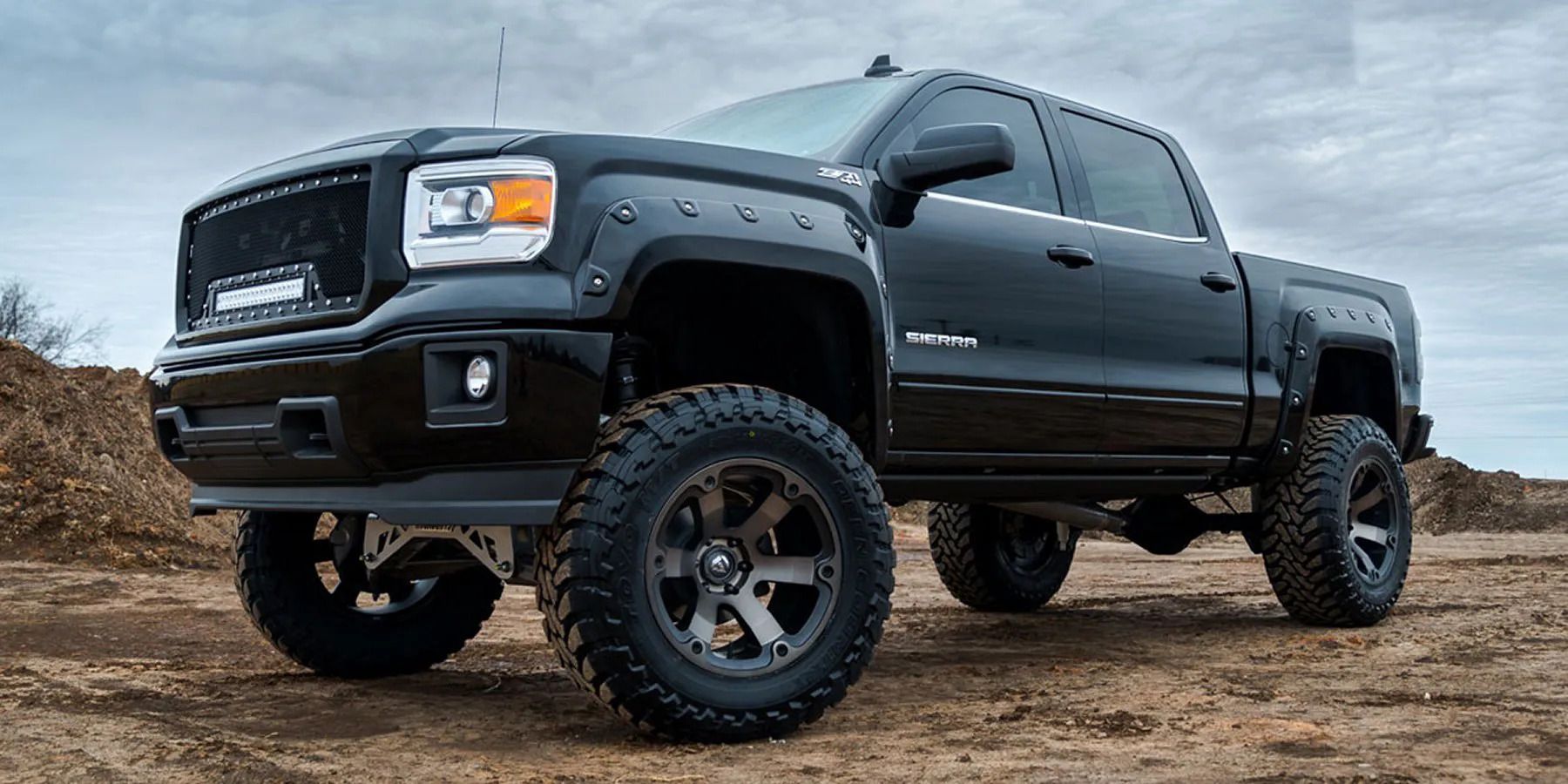 Black lifted pickup truck on dirt. Black lifted pickup truck on dirt.