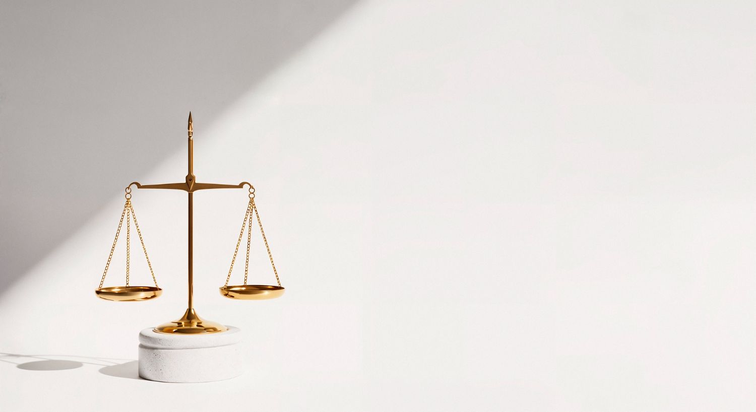Gold scales of justice on a white background