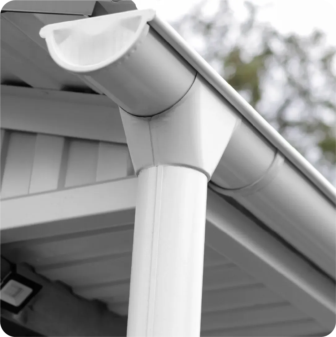 A white gutter on the side of a house