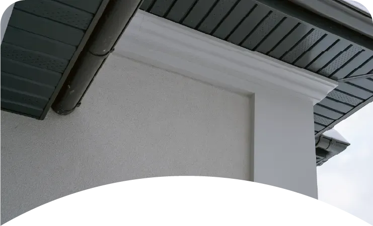 A white house with a blue roof and a white garage door