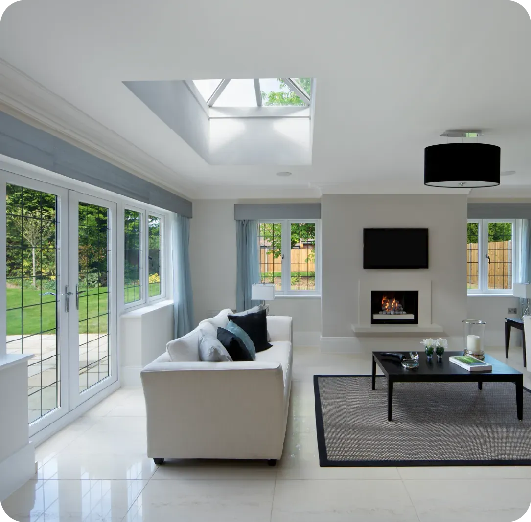 A living room with a white couch and a fireplace