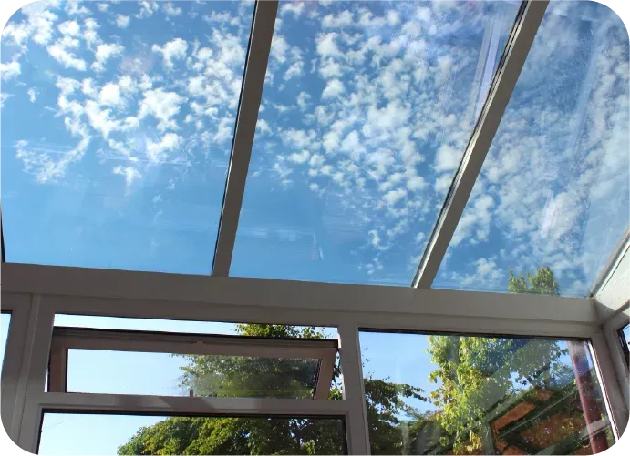 A glass roof with a blue sky behind it