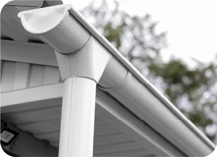 A white gutter on the side of a house