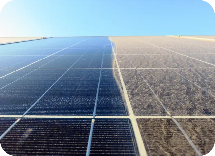 A row of solar panels in the desert with a blue sky in the background