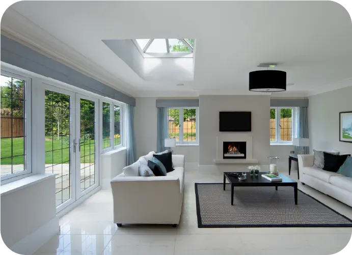 A living room with white furniture and a fireplace