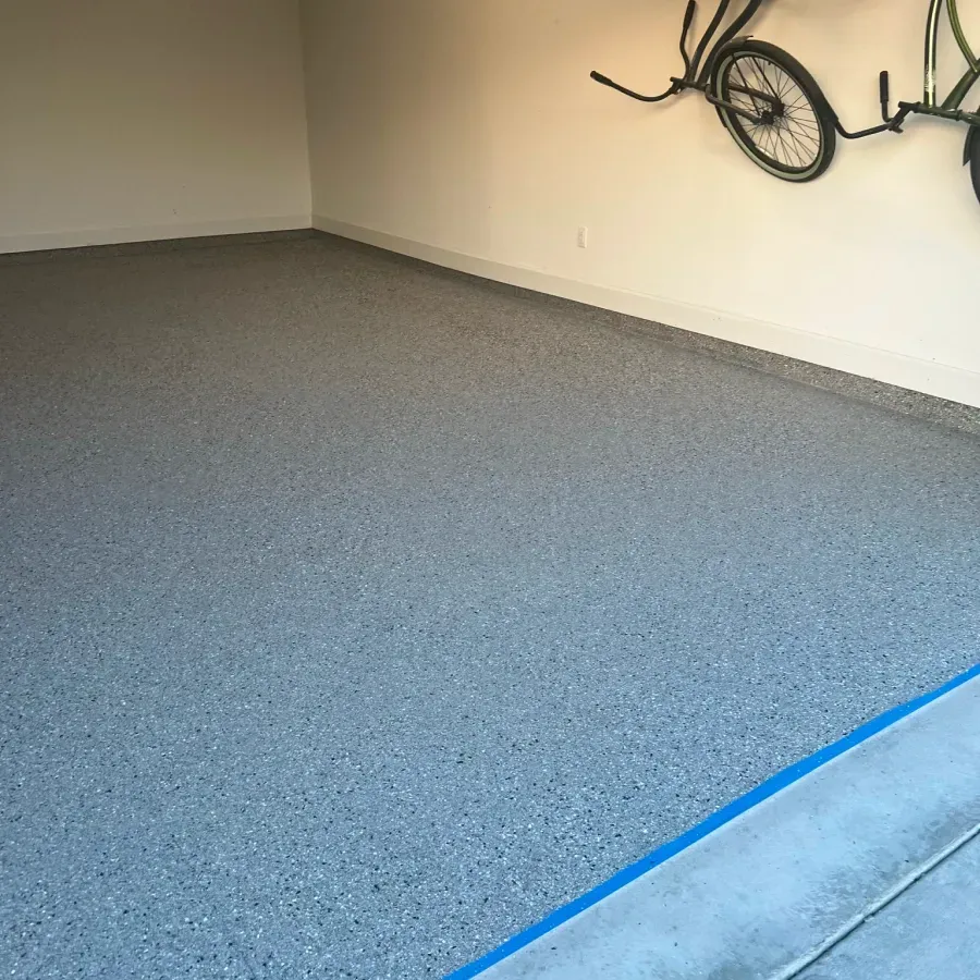 A bicycle is hanging on a wall in a garage.