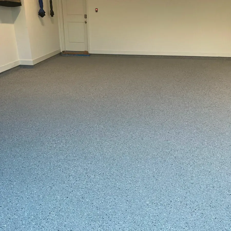 A garage with a gray floor and white walls.