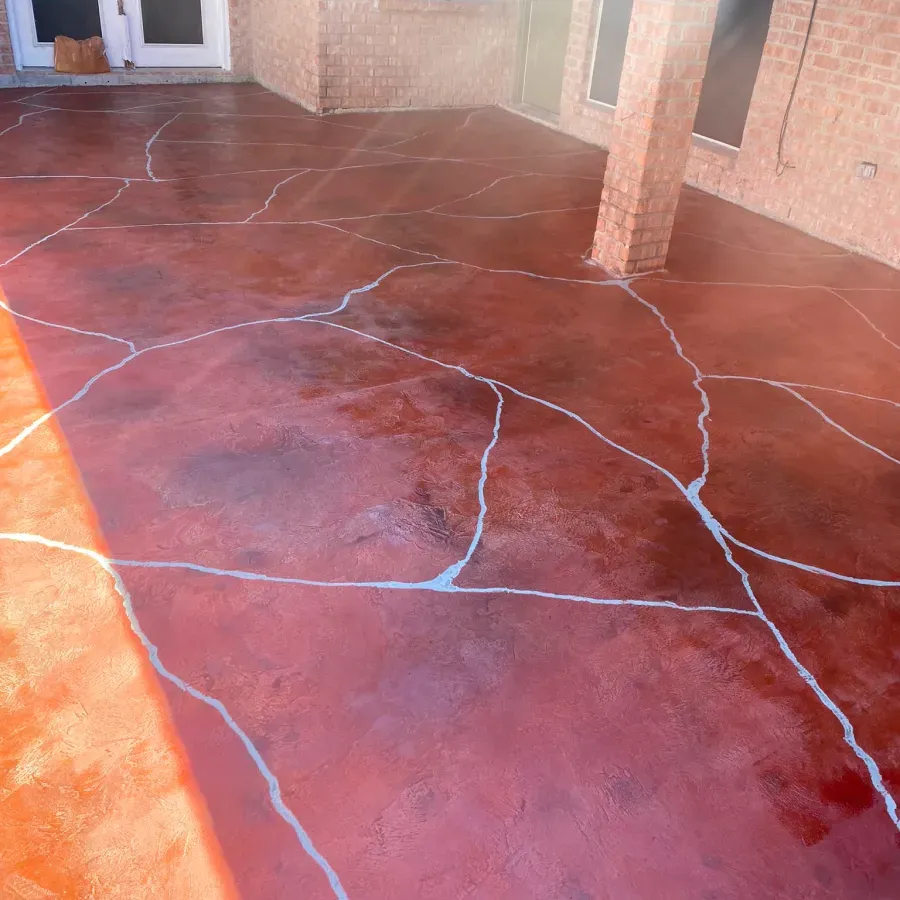 A brick building with a red concrete floor