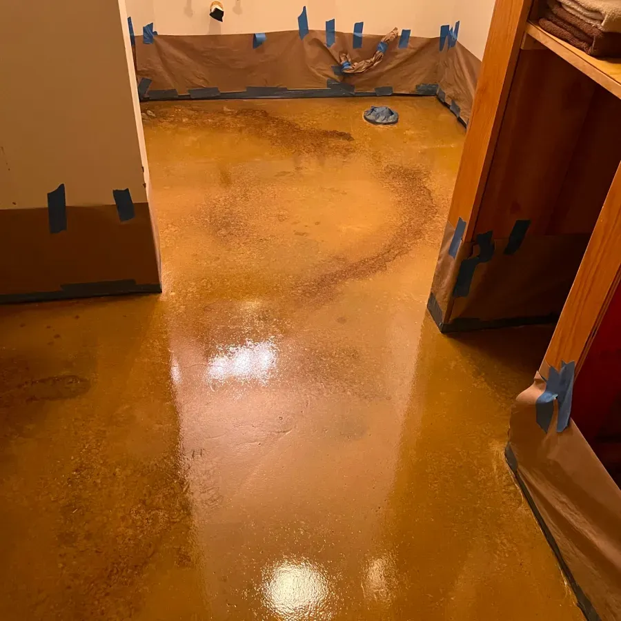 A room with a yellow floor and a closet.