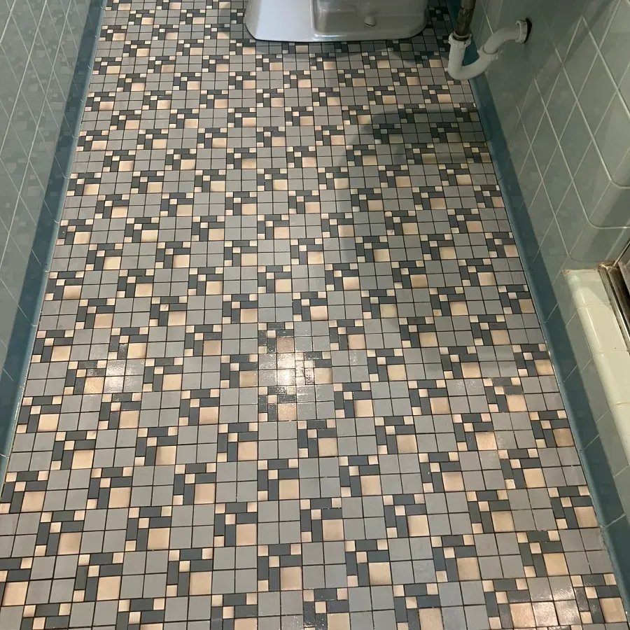 A bathroom with a tiled floor and a sink