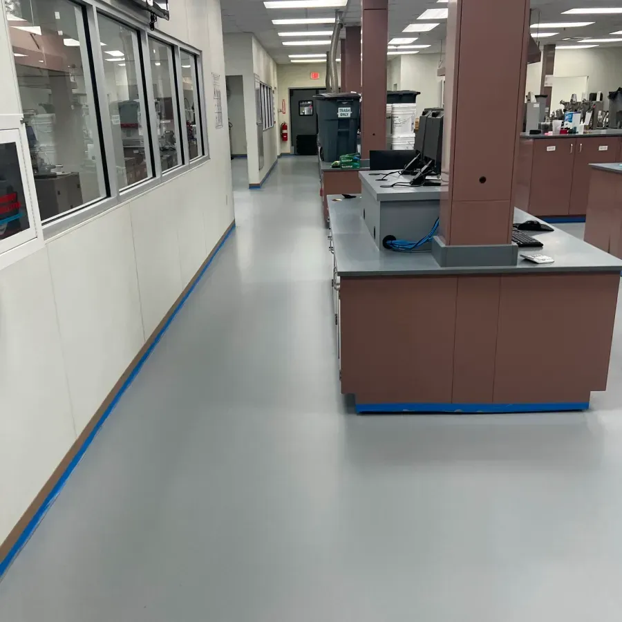 A long hallway in a building with a lot of windows