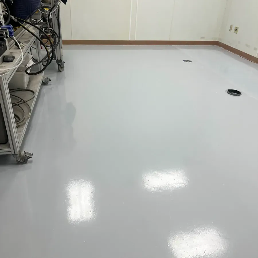 A clean room with a white floor and a vacuum cleaner on the floor.