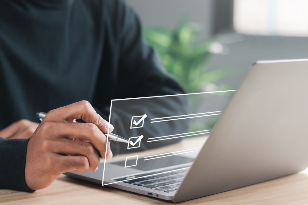 Person answering survey questions on a laptop