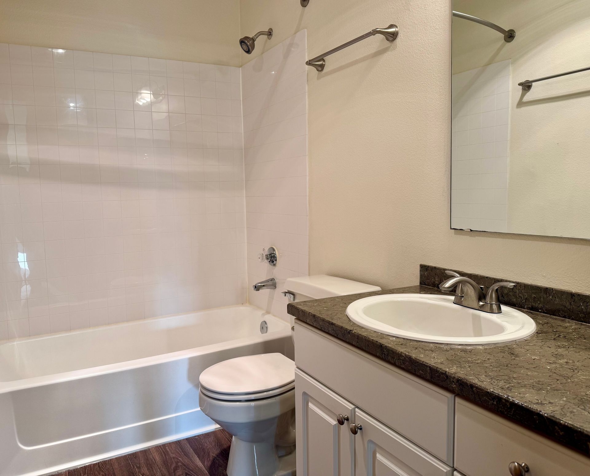 A bathroom with a toilet , sink and bathtub