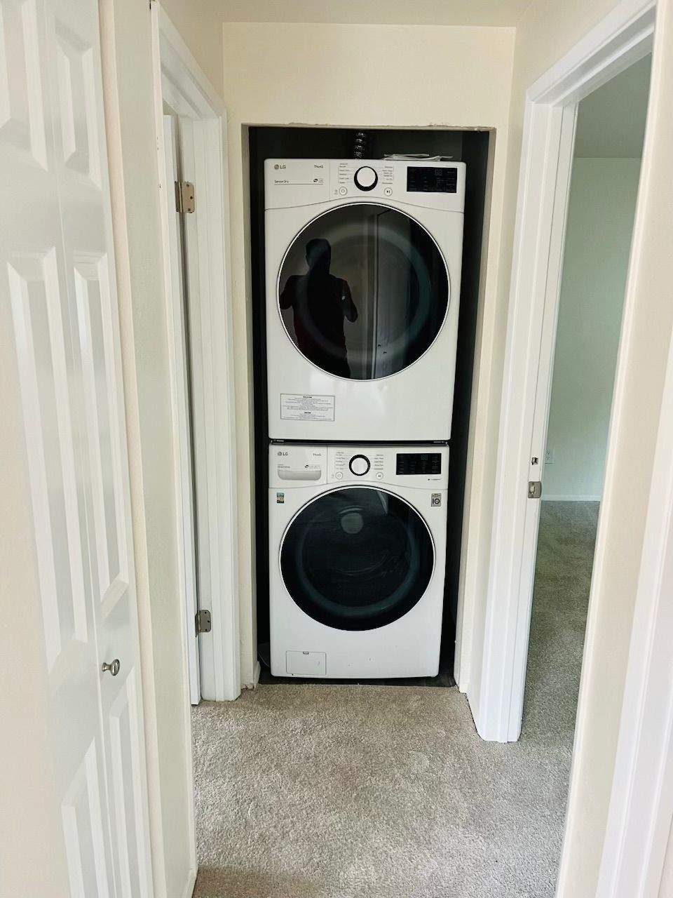 A washer and dryer are stacked on top of each other in a closet
