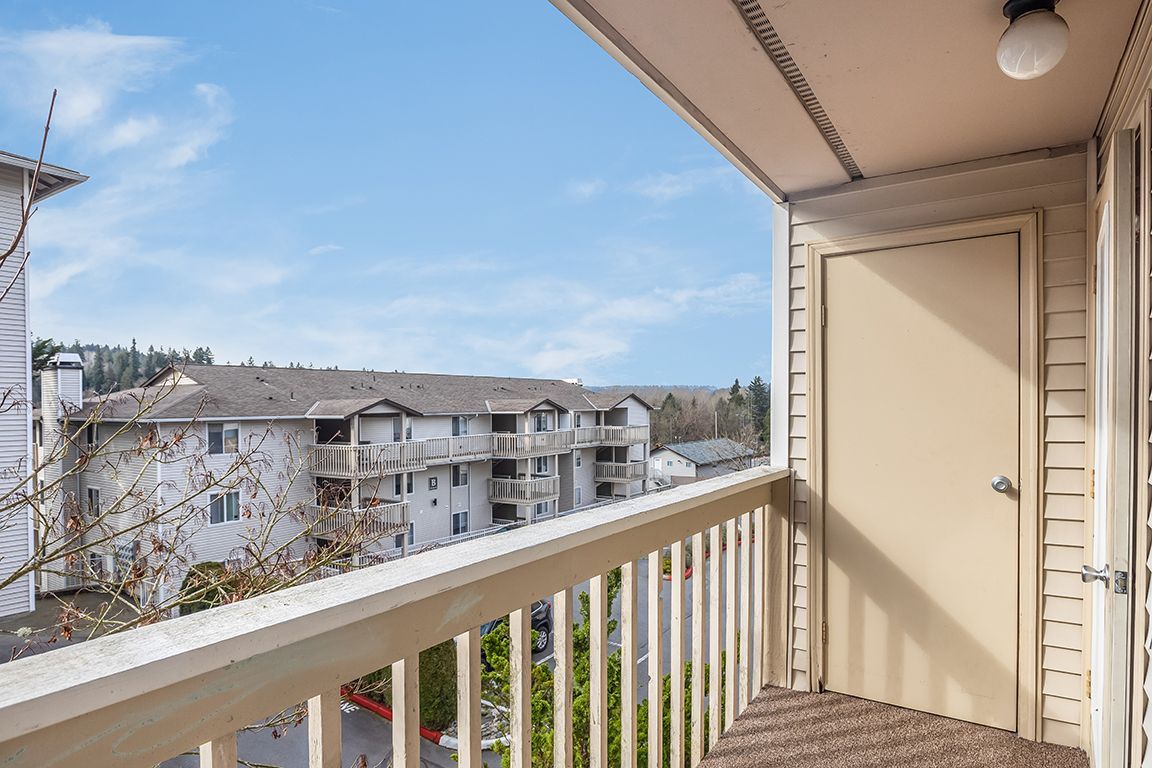 There is a balcony with a view of a building.