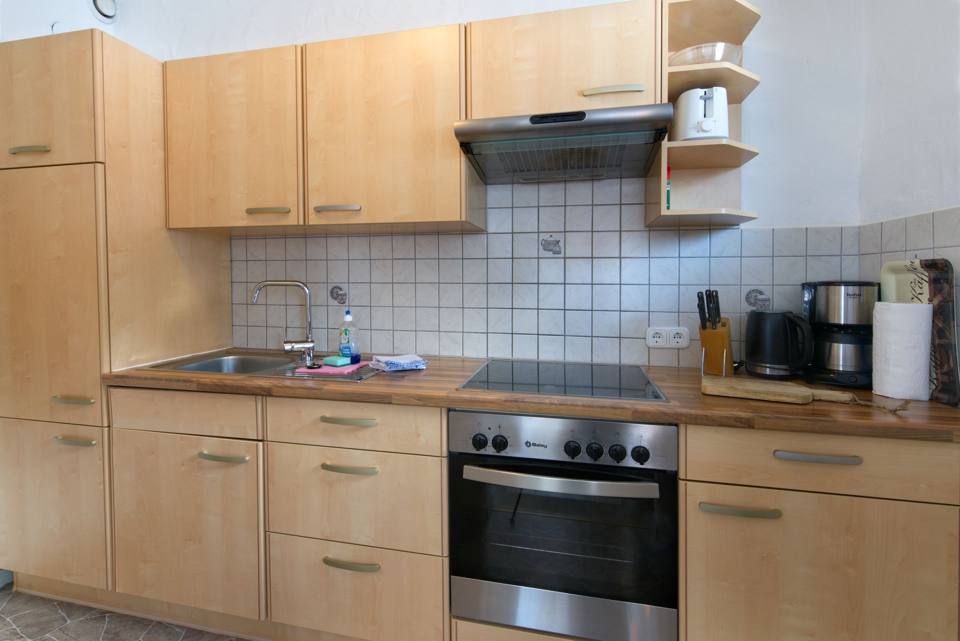 A kitchen with stainless steel appliances and wooden cabinets