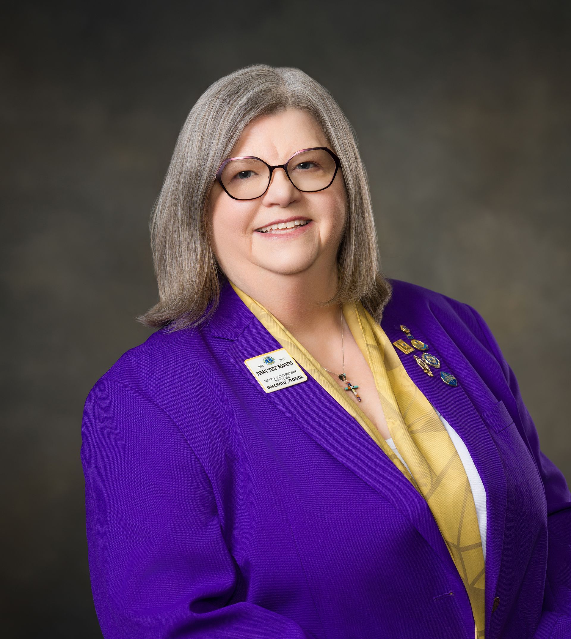 A man with a beard is wearing a suit and tie