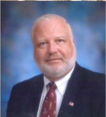 A man with a beard is wearing a suit and tie