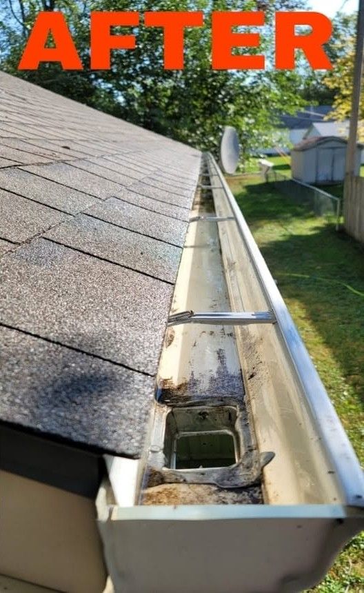Roof gutter after repair with exposed downspout outlet and shingle roof edge