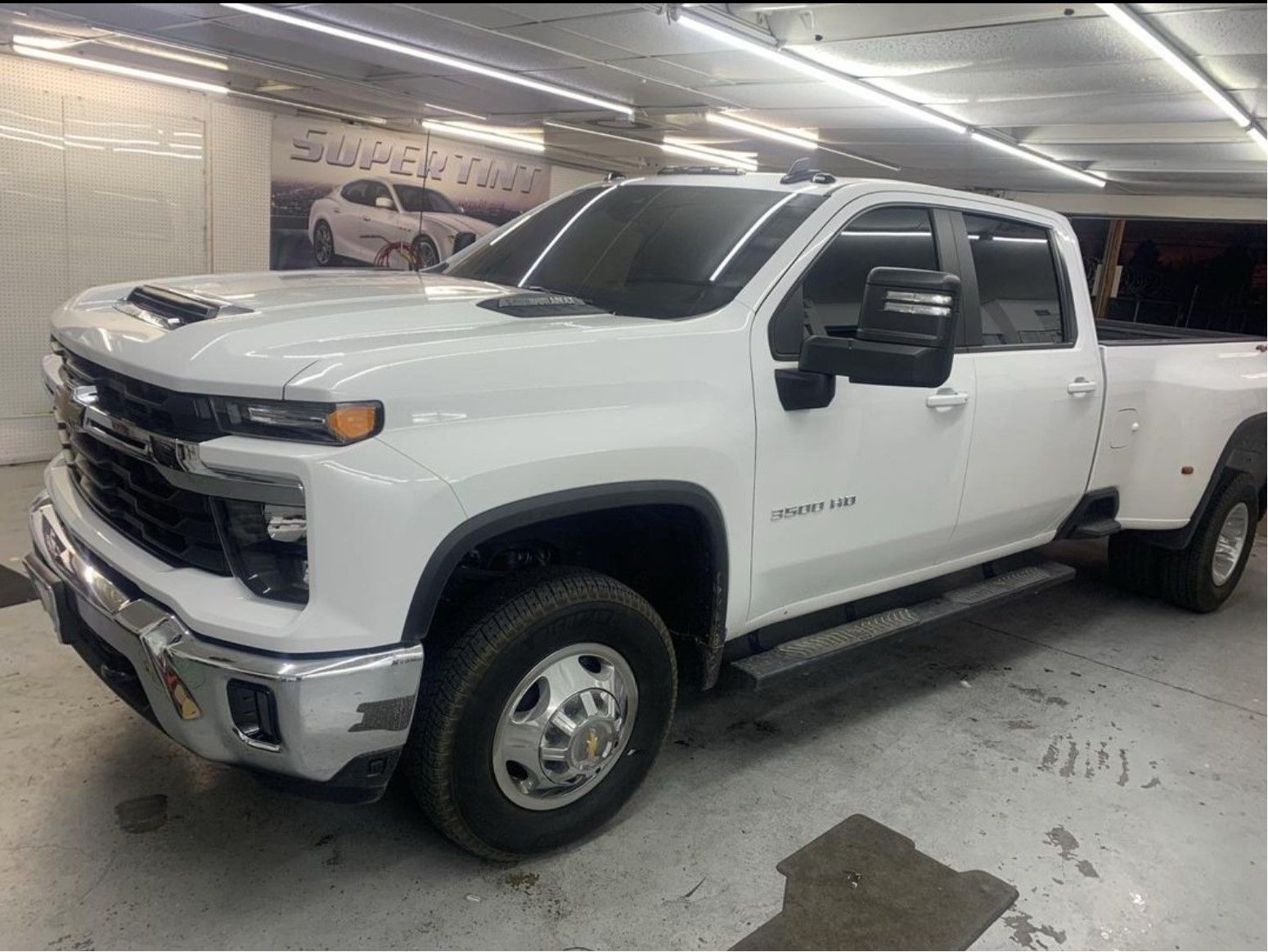Window tinting a white pickup truck