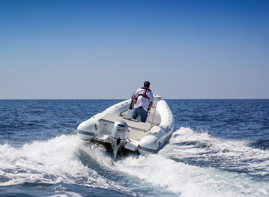 La parte posteriore di una barca con un divano e una vista sull'acqua.