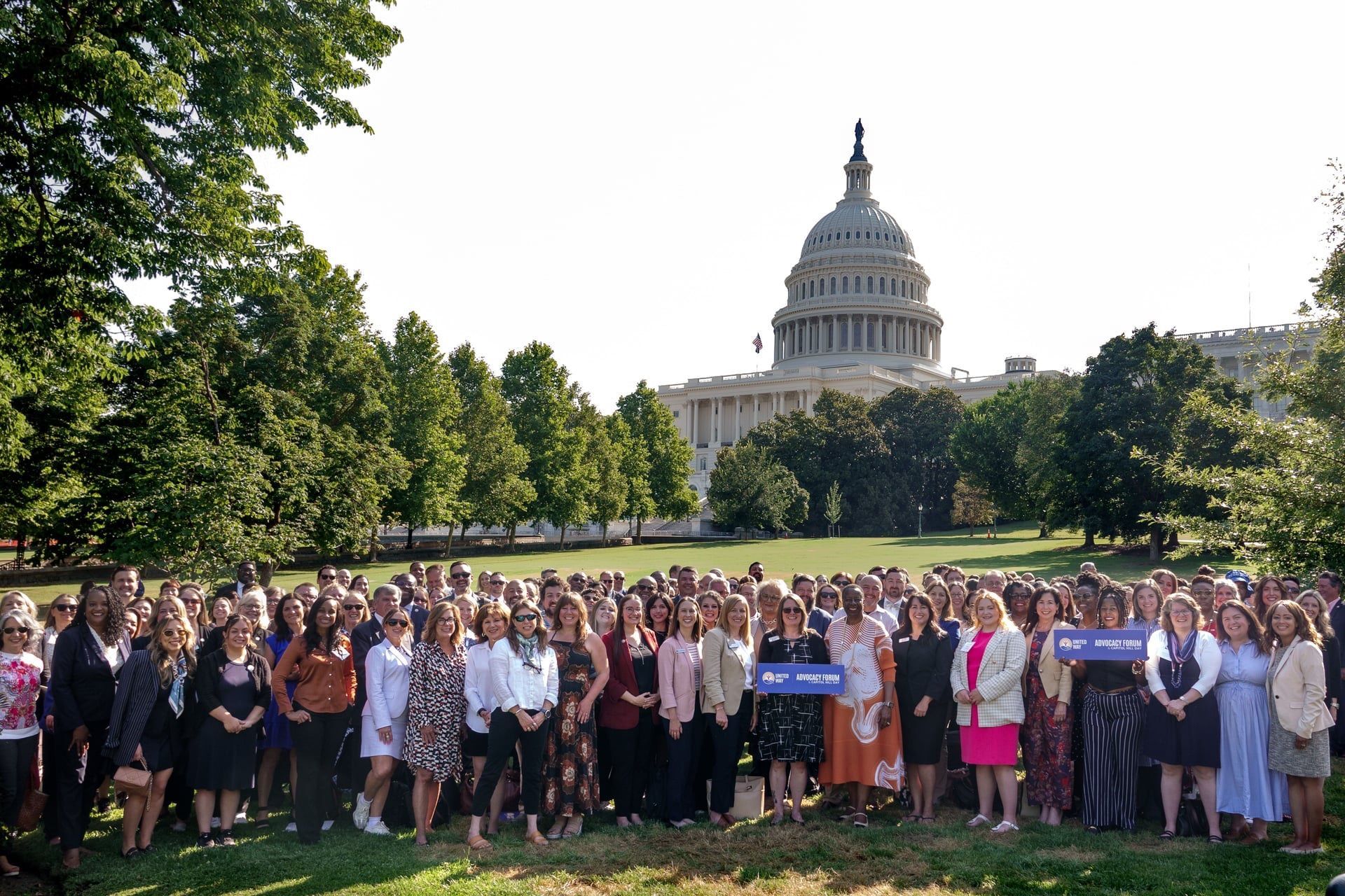 A large group of people standing in front of the Capitol building