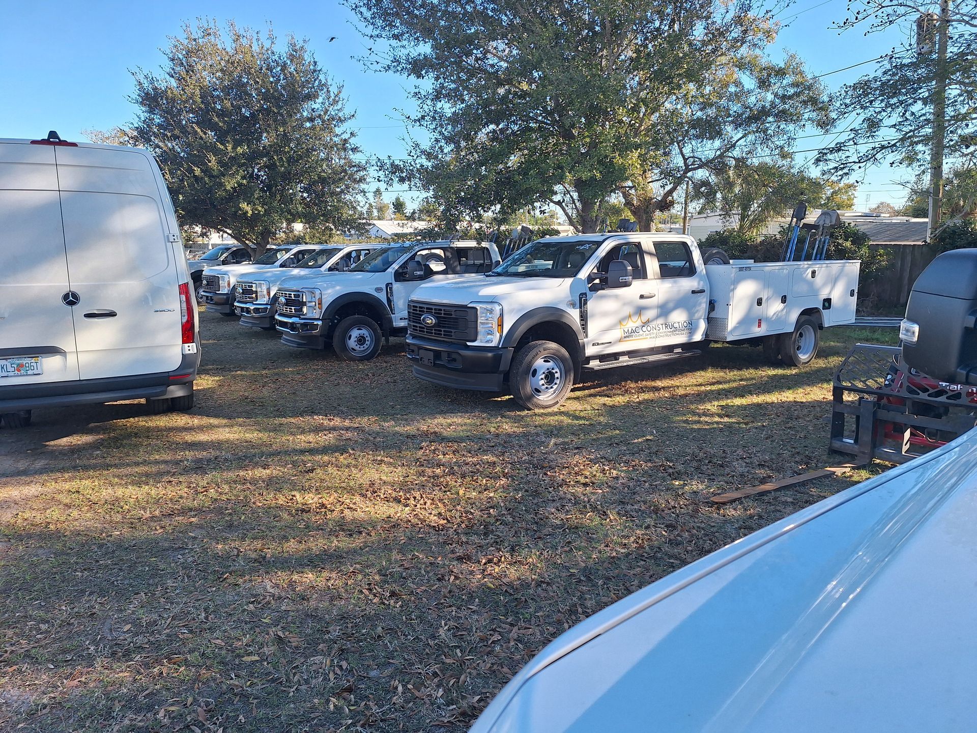 White Porsche Panamera parked under a covered area, with tinted windows and black rims.