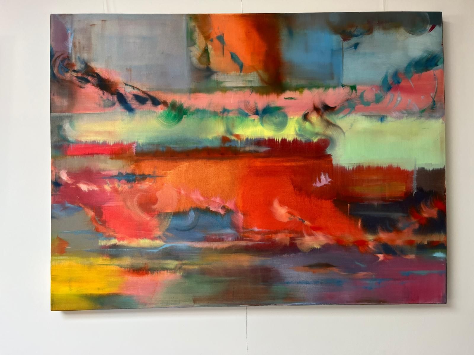 Abstract painting with horizontal bands of red, orange, green, yellow, and blue hues.