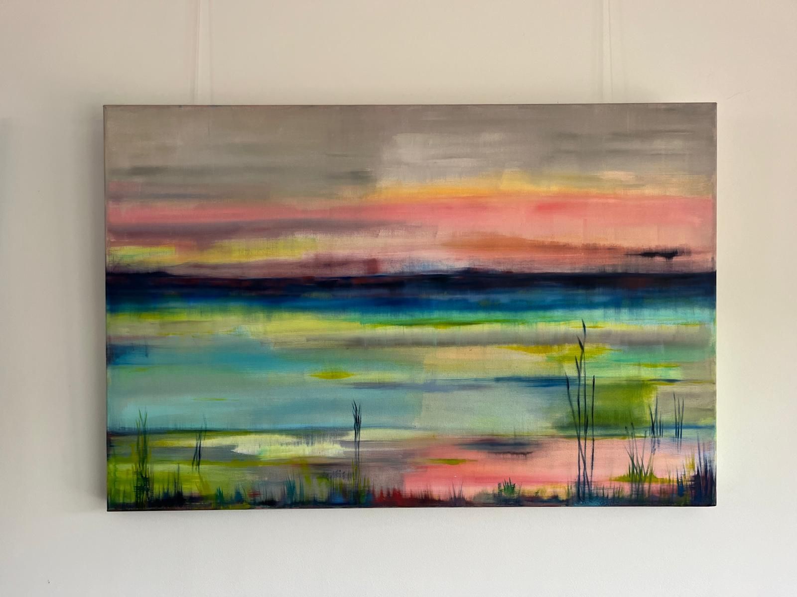 Abstract painting of a colorful landscape. Pink, blue, yellow and green colors on a canvas.