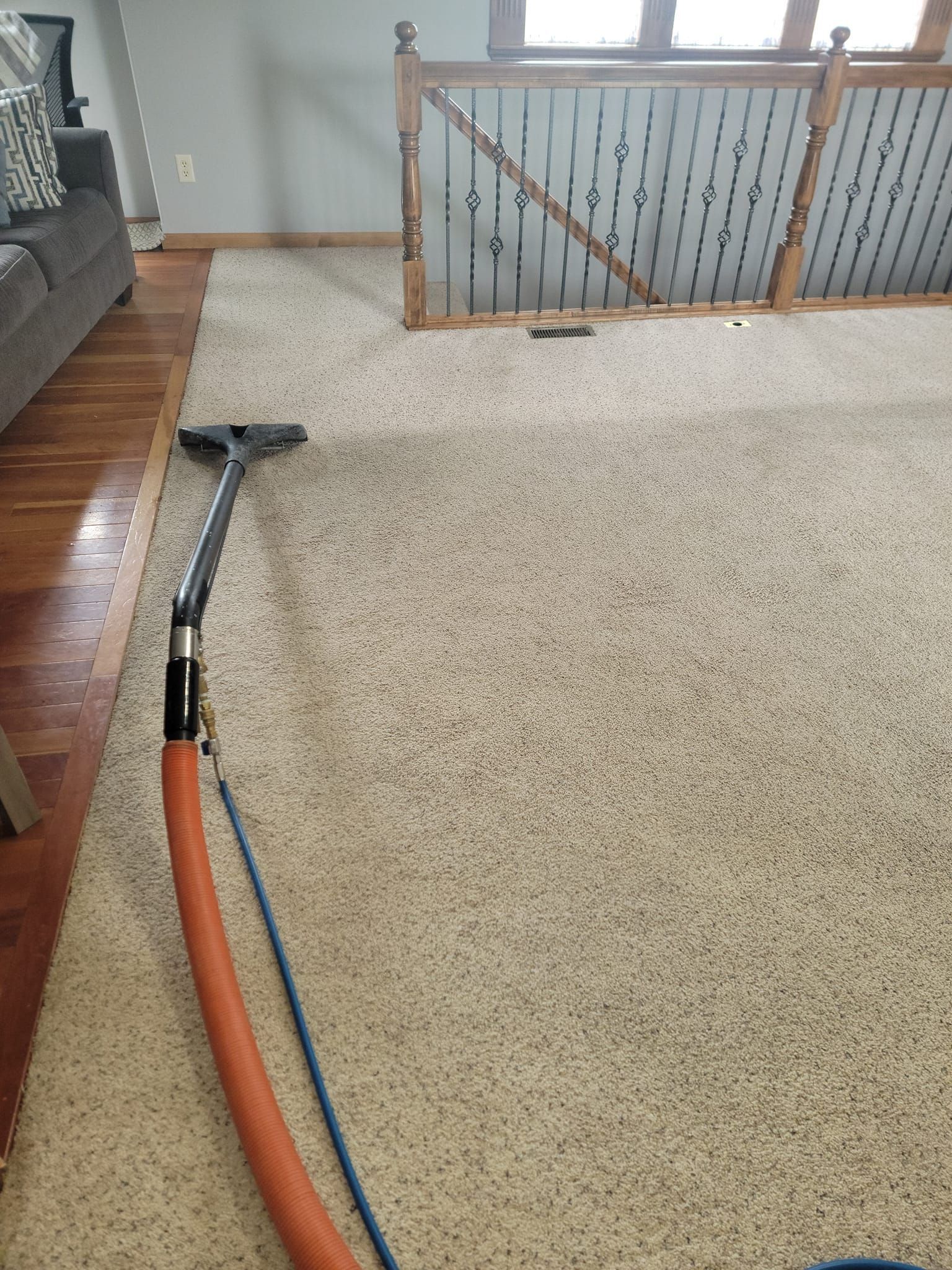 A vacuum cleaner is sitting on top of a carpet in a living room.