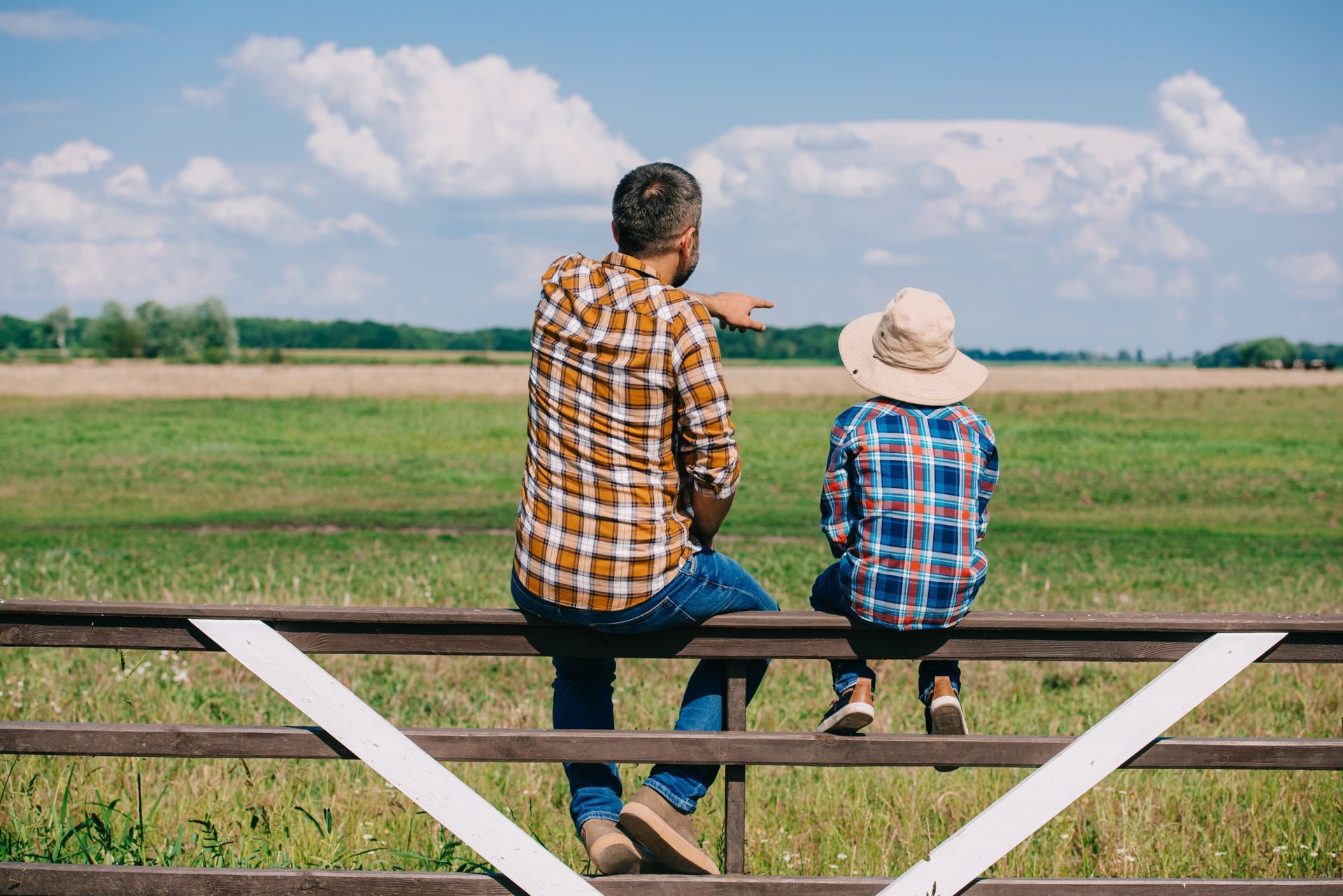 parent and child look at farm with insurance