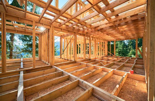 The inside of a wooden house under construction.