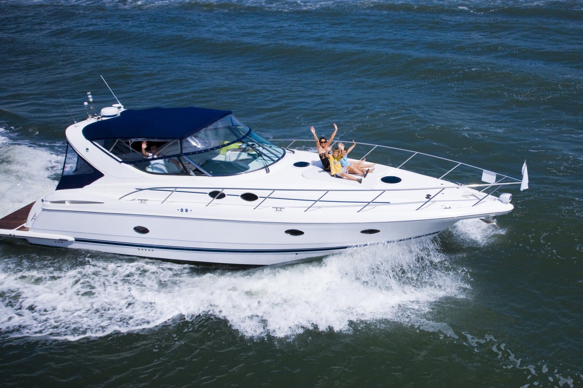 People sitting on deck of large speedboat on the sea in Adelaide.