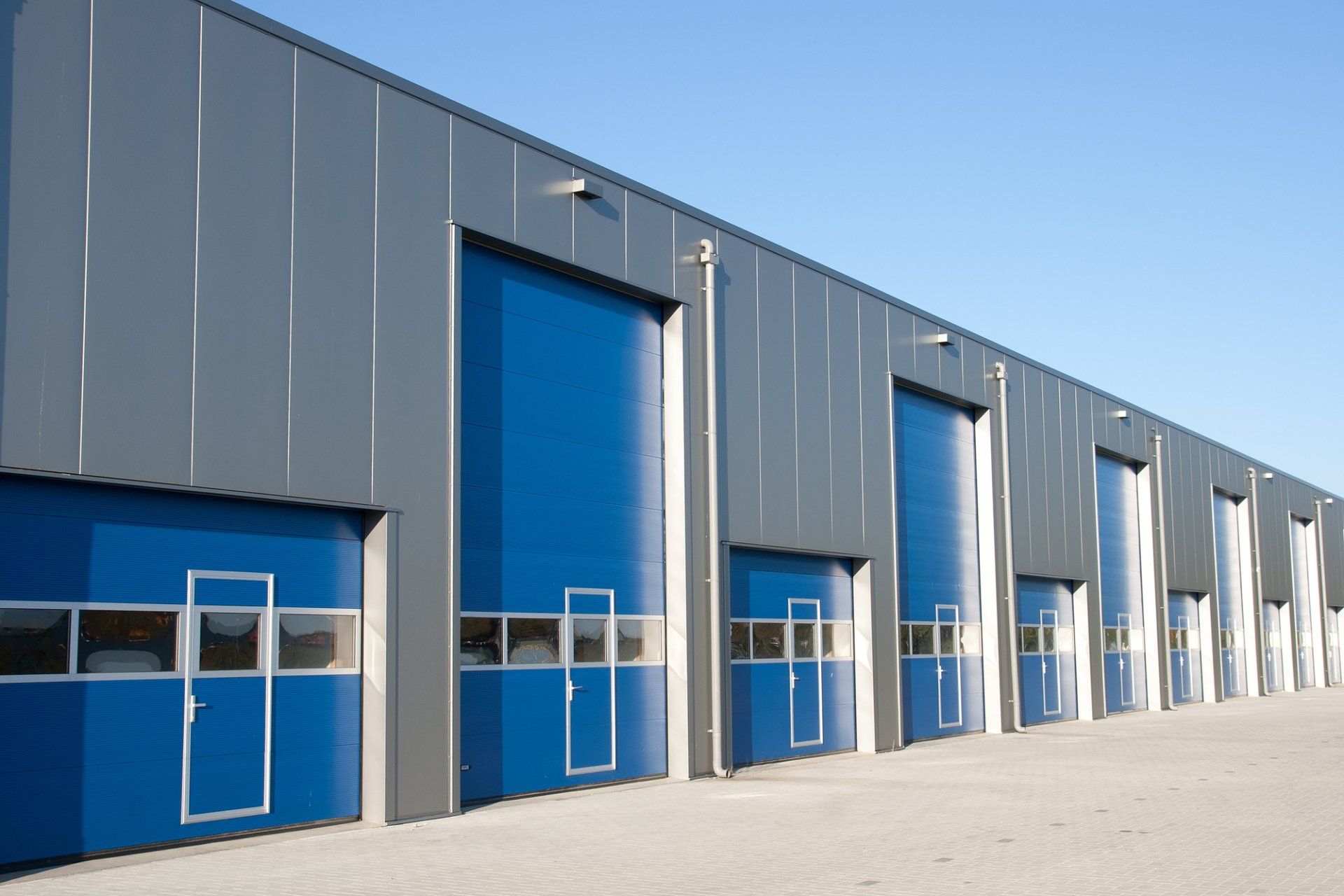 Outdoor shot of commercial building with large blue doors in Adelaide.