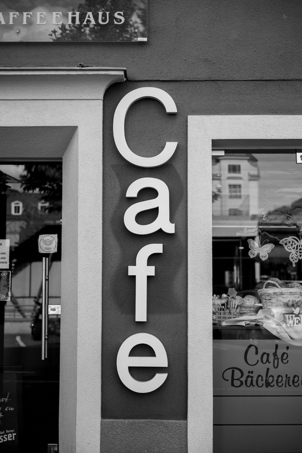 A black and white photo of a cafe sign