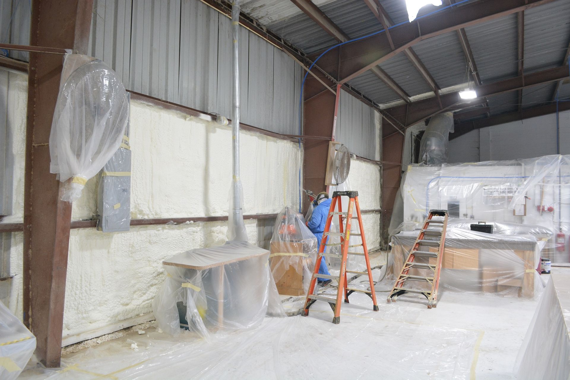 Interior of an attic with spray foam insulation on the rafters.