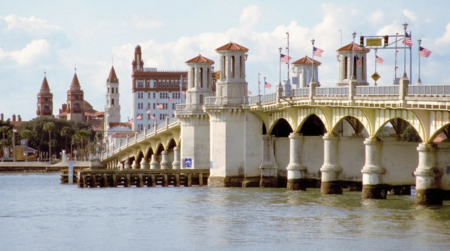 Bridge of Lions in St. Augustine, Florida, white arched bridge with towers and buildings in the background.