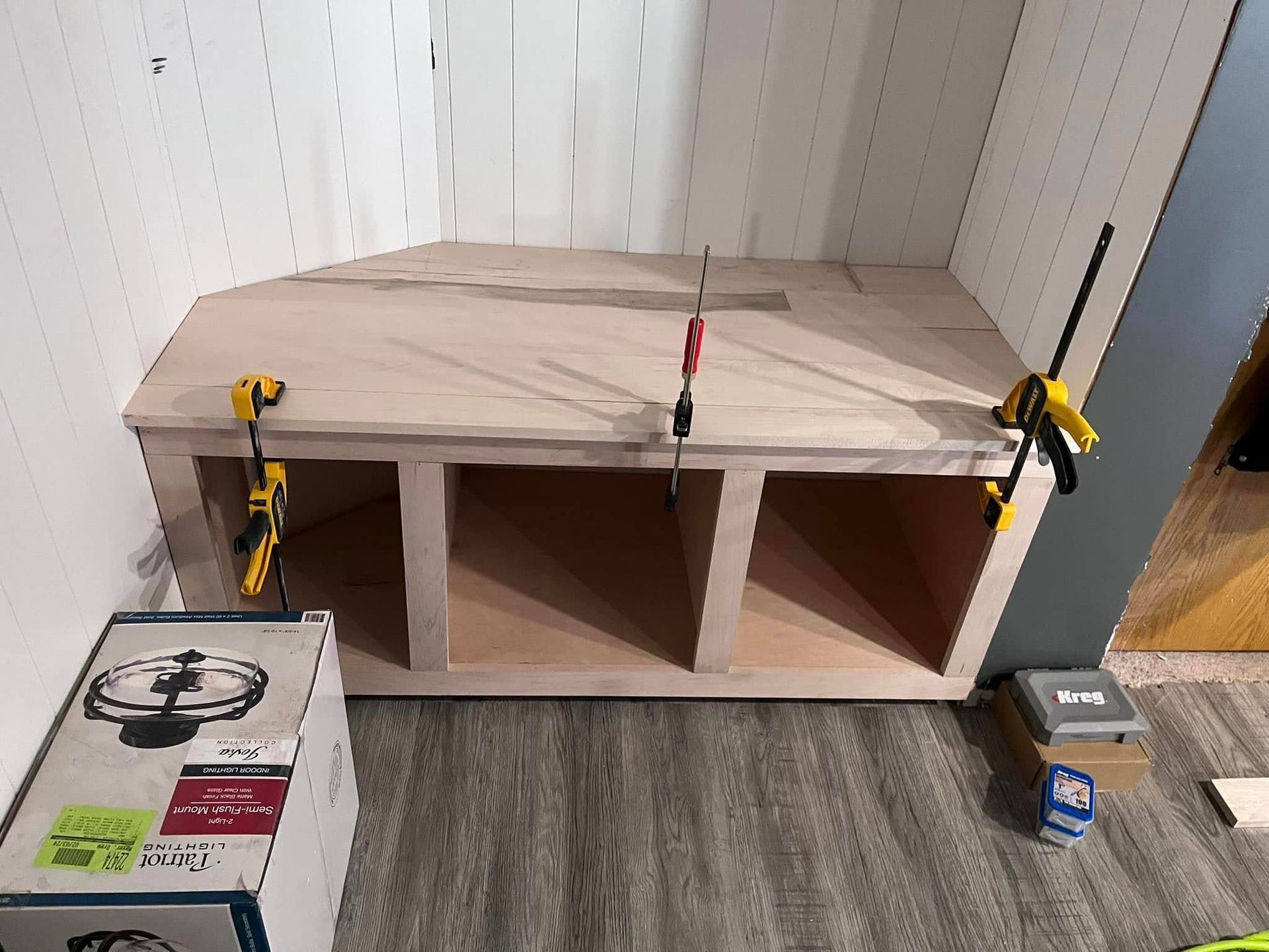 A wooden bench is being built in a room.