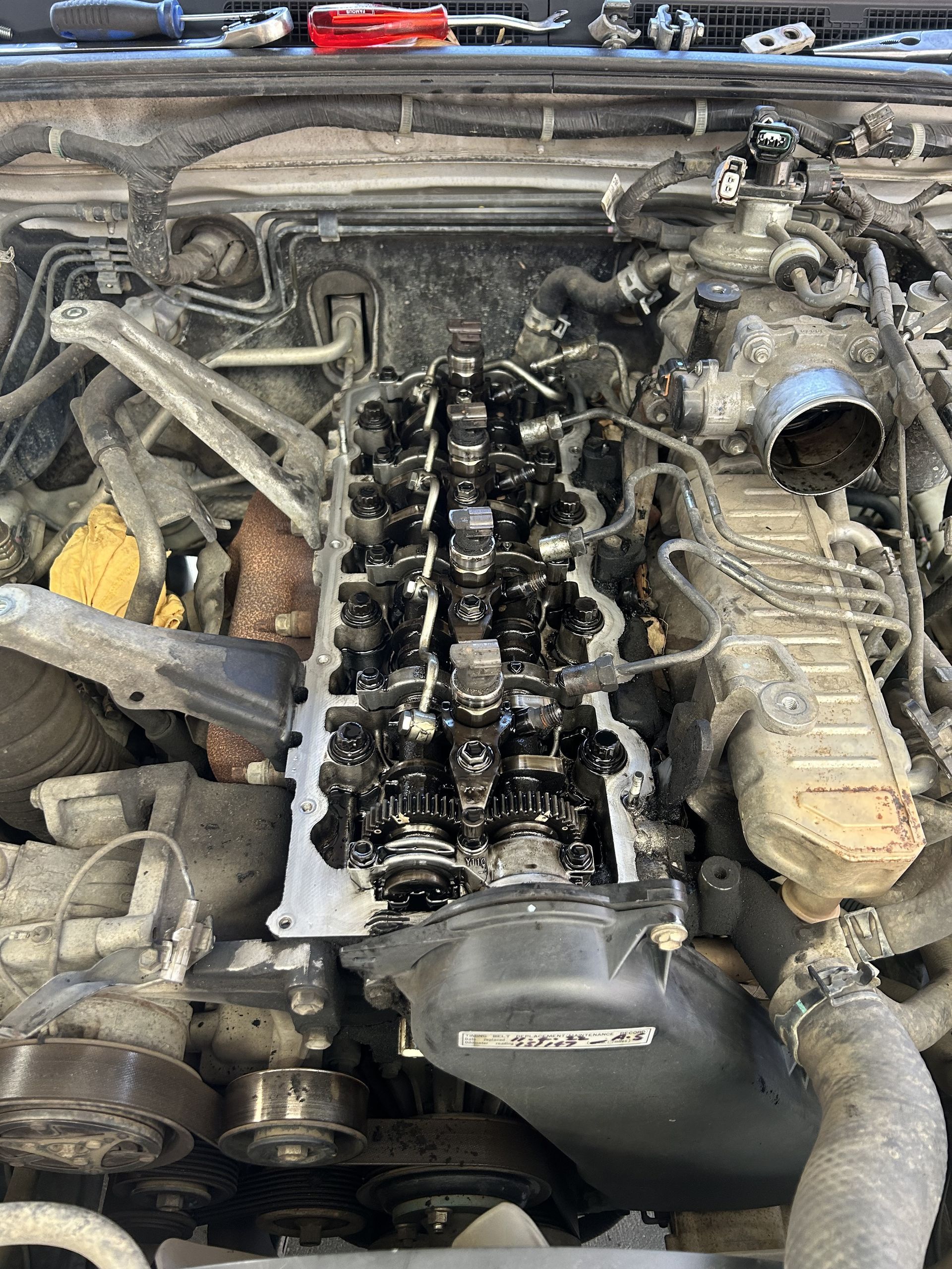Car engine with valve cover removed, showing internal components. — All Auto & Mechanical in The Entrance North, NSW
