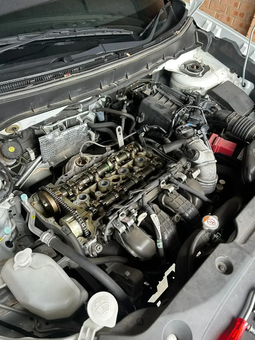 Car Engine Bay With Parts Exposed; Oil Stains Visible on Engine — All Auto & Mechanical in The Entrance North, NSW