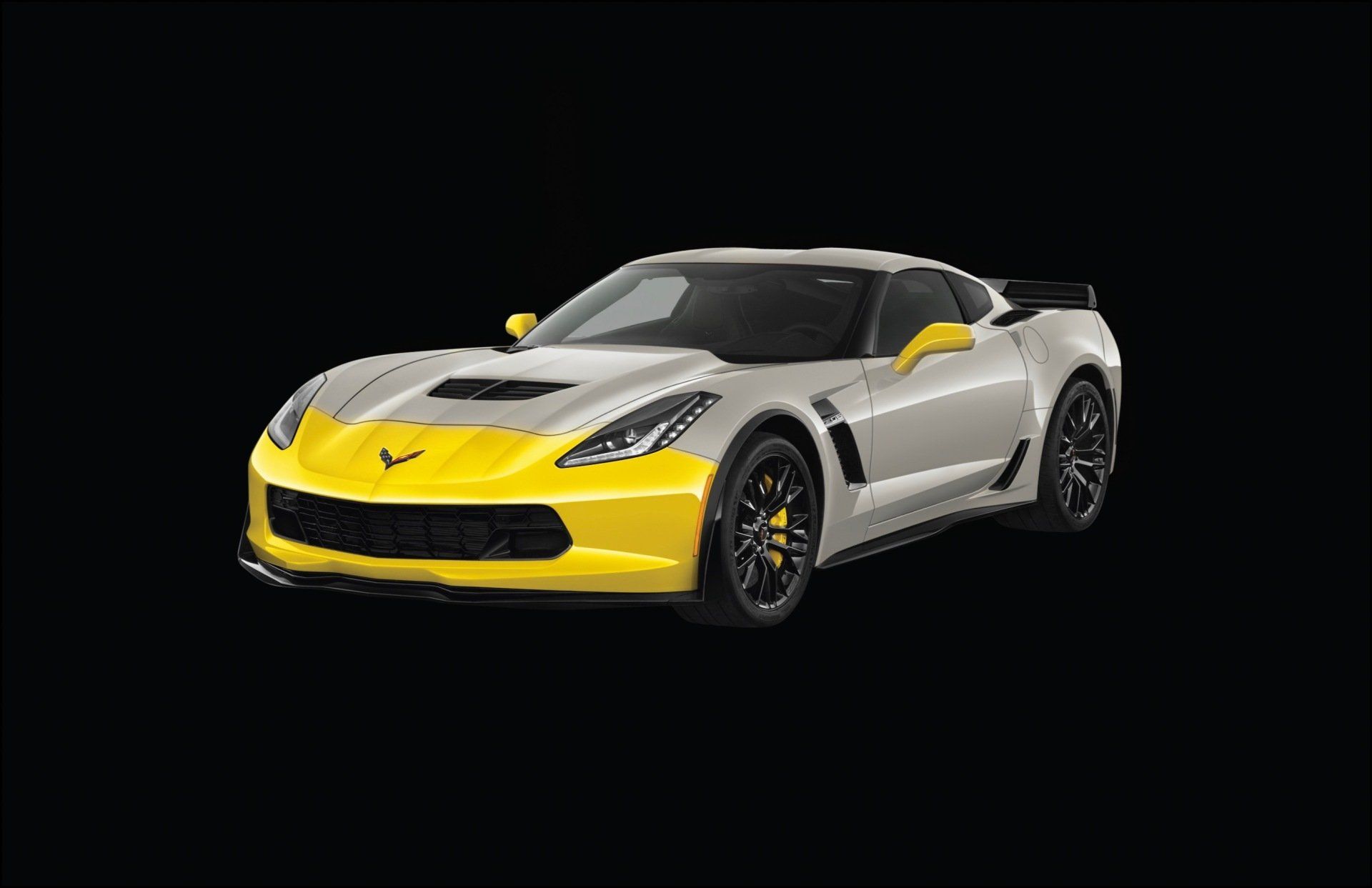 A silver and yellow sports car on a black background.