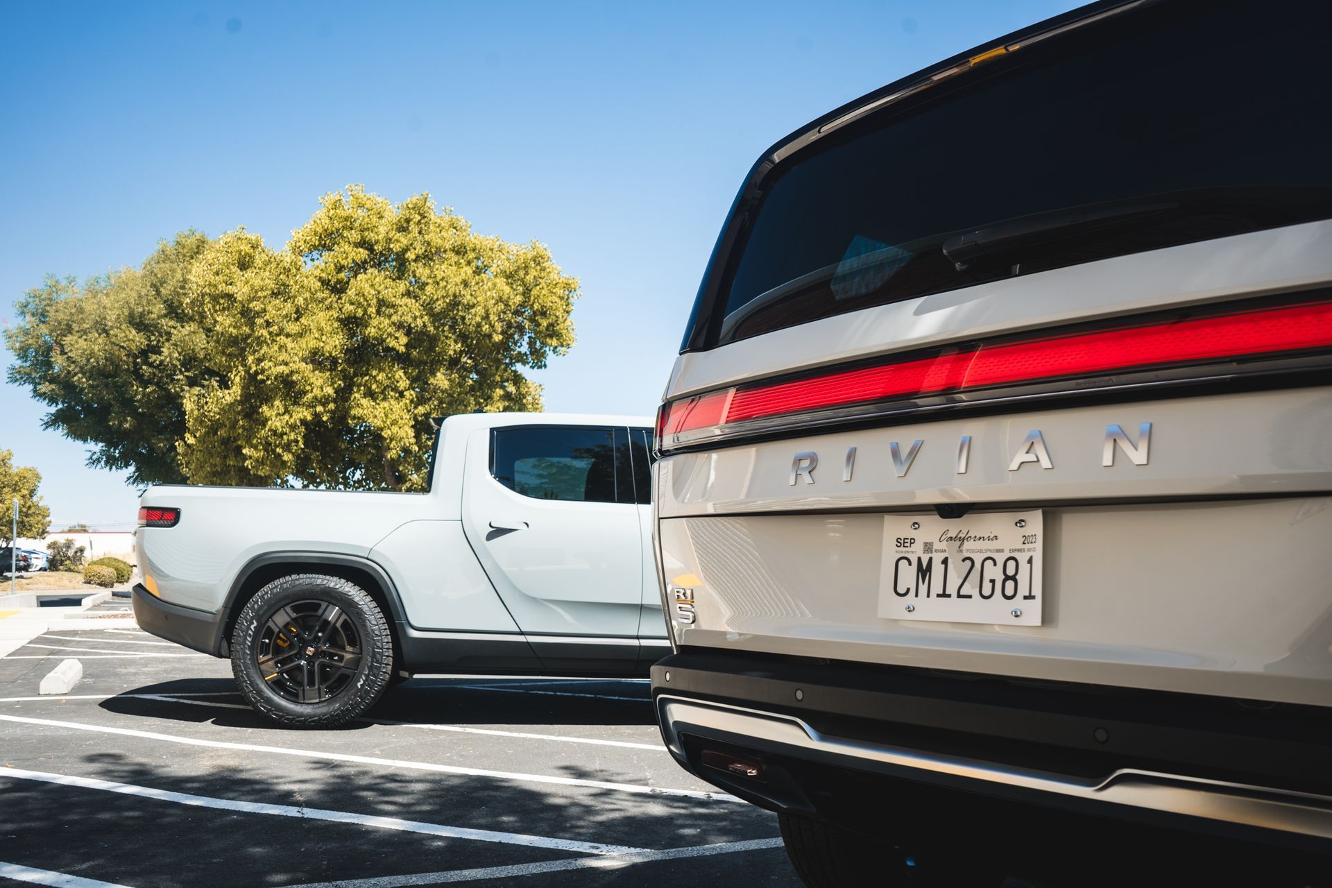 A white truck and a silver suv are parked next to each other in a parking lot.