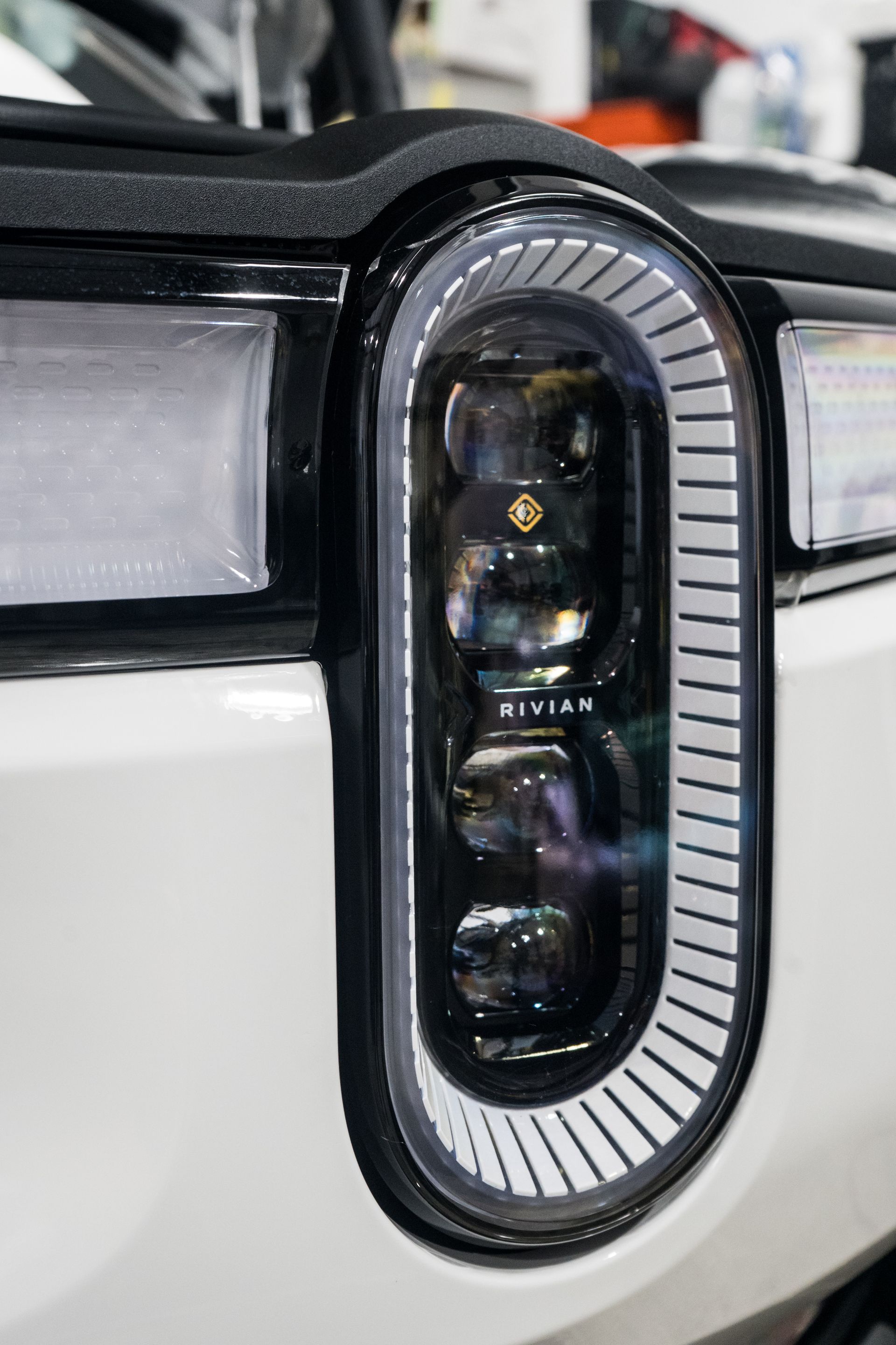 A close up of a headlight on a white car.