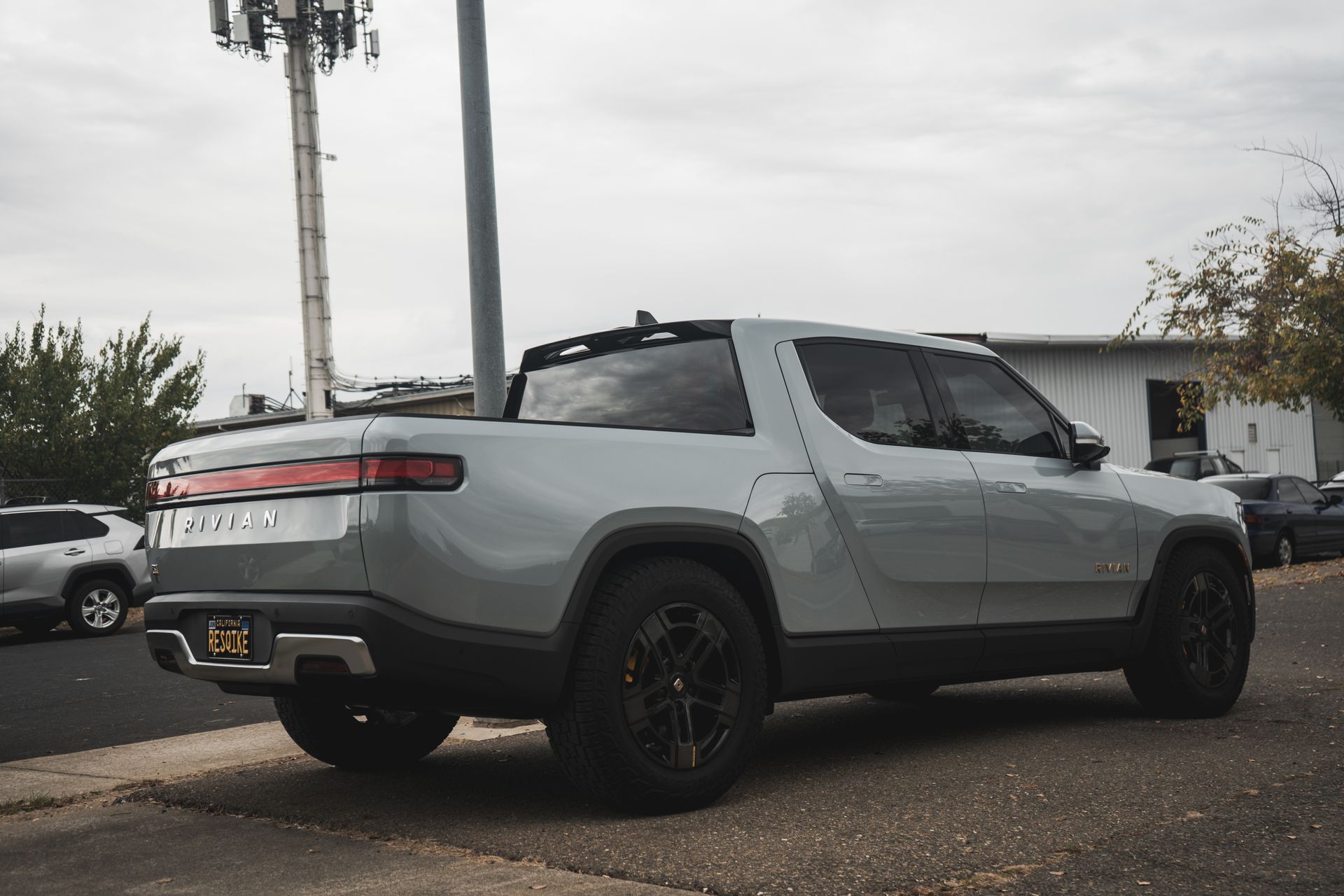 A silver truck is parked on the side of the road.