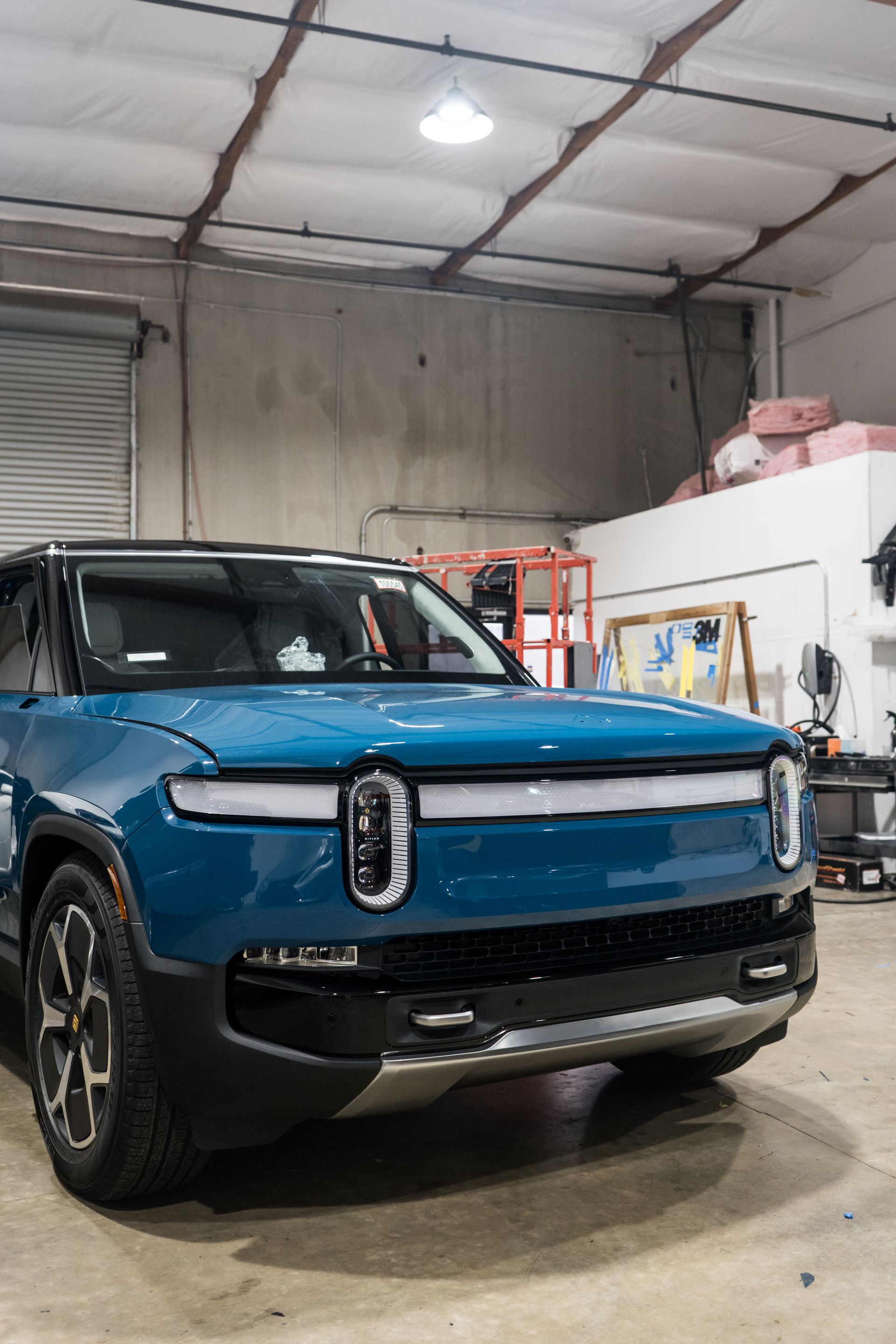 A blue suv is parked in a garage.