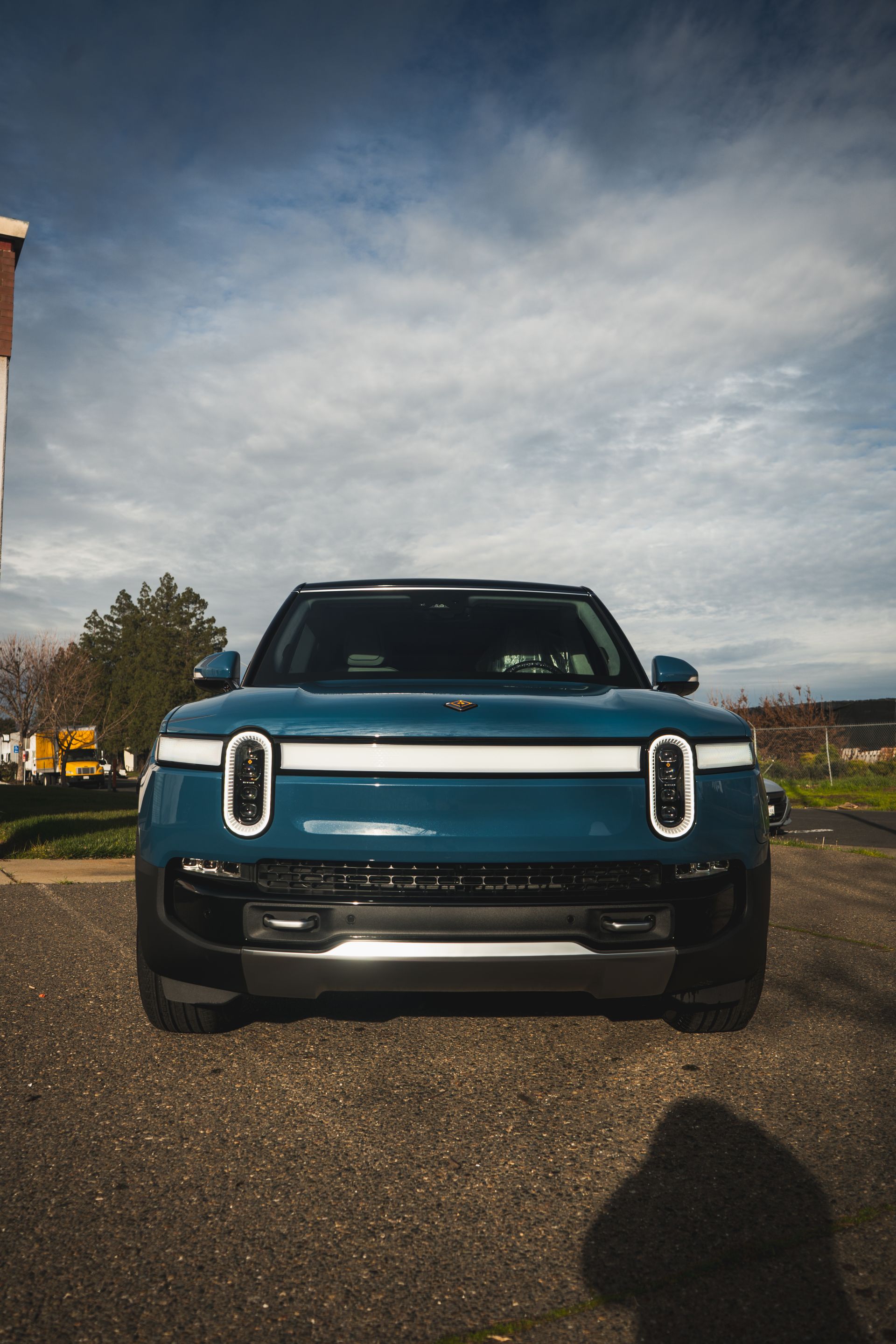 A blue suv is parked on the side of the road.