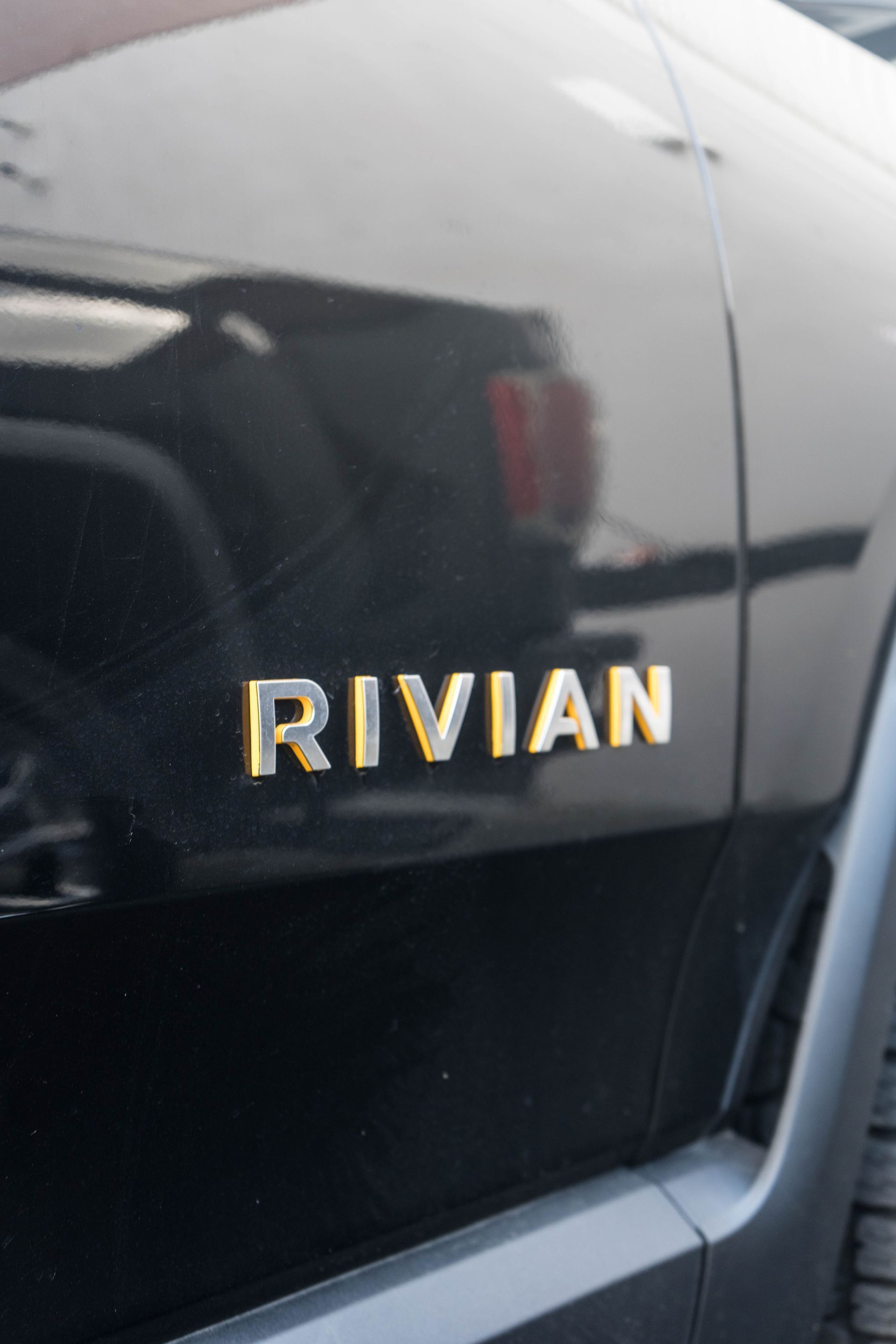 The word rivian is on the side of a car