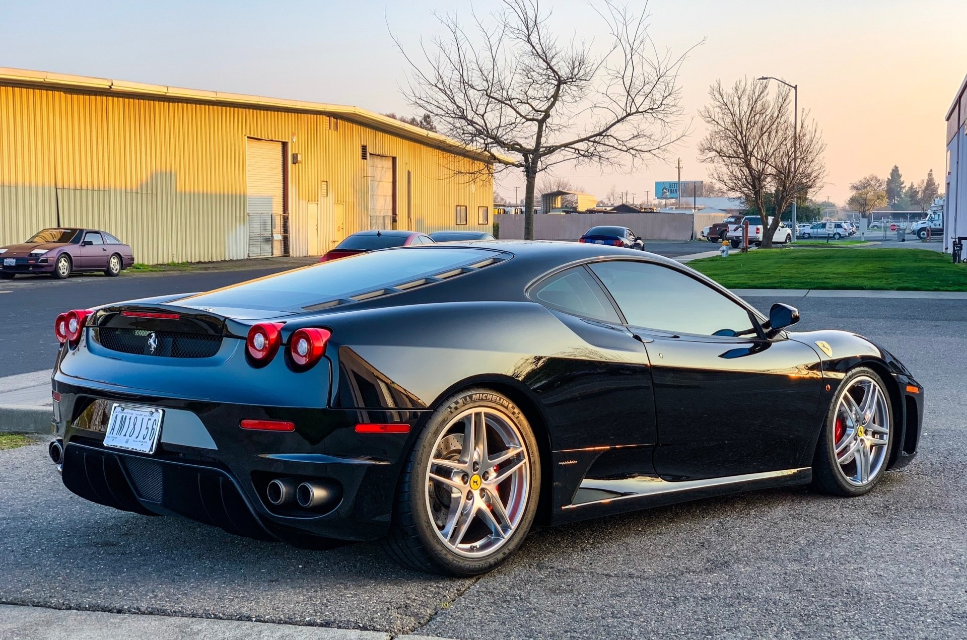 A black sports car is parked in front of a building