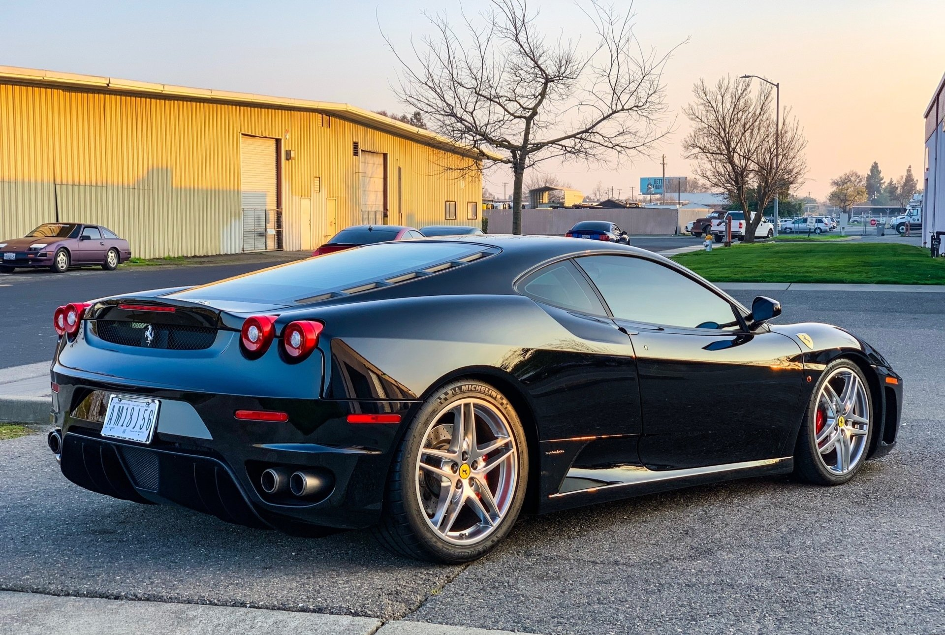 A black sports car is parked in front of a building